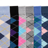 Six pairs of men's dress socks with argyle diamond patterns, shown in a side-by-side vertical arrangement. The colors include light blue, black, gray, navy, pink, and blue, with some pairs featuring yellow and purple accents.