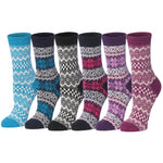 Six pairs of patterned crew socks arranged side by side on a white background. The socks come in blue, navy, black, gray, pink, and purple colorways, each featuring a classic Fair Isle geometric and floral pattern.