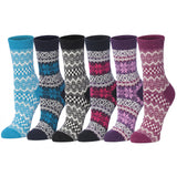 Six pairs of patterned crew socks arranged side by side on a white background. The socks come in blue, navy, black, gray, pink, and purple colorways, each featuring a classic Fair Isle geometric and floral pattern.