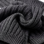 Stack of dark gray ribbed socks on a white background