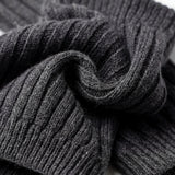Stack of dark gray ribbed socks on a white background