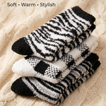 Stack of zebra-striped socks on a textured beige surface with text 'Cozy Color Variety, Soft, Warm, Stylish'.