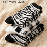 Stack of zebra-striped socks on a textured beige surface with text 'Cozy Color Variety, Soft, Warm, Stylish'.
