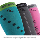 Three Ronnox compression socks shown in teal, dark gray, and pink, arranged diagonally on a white background with the text 'Breathable • Lightweight • All-Day Comfort' at the bottom.