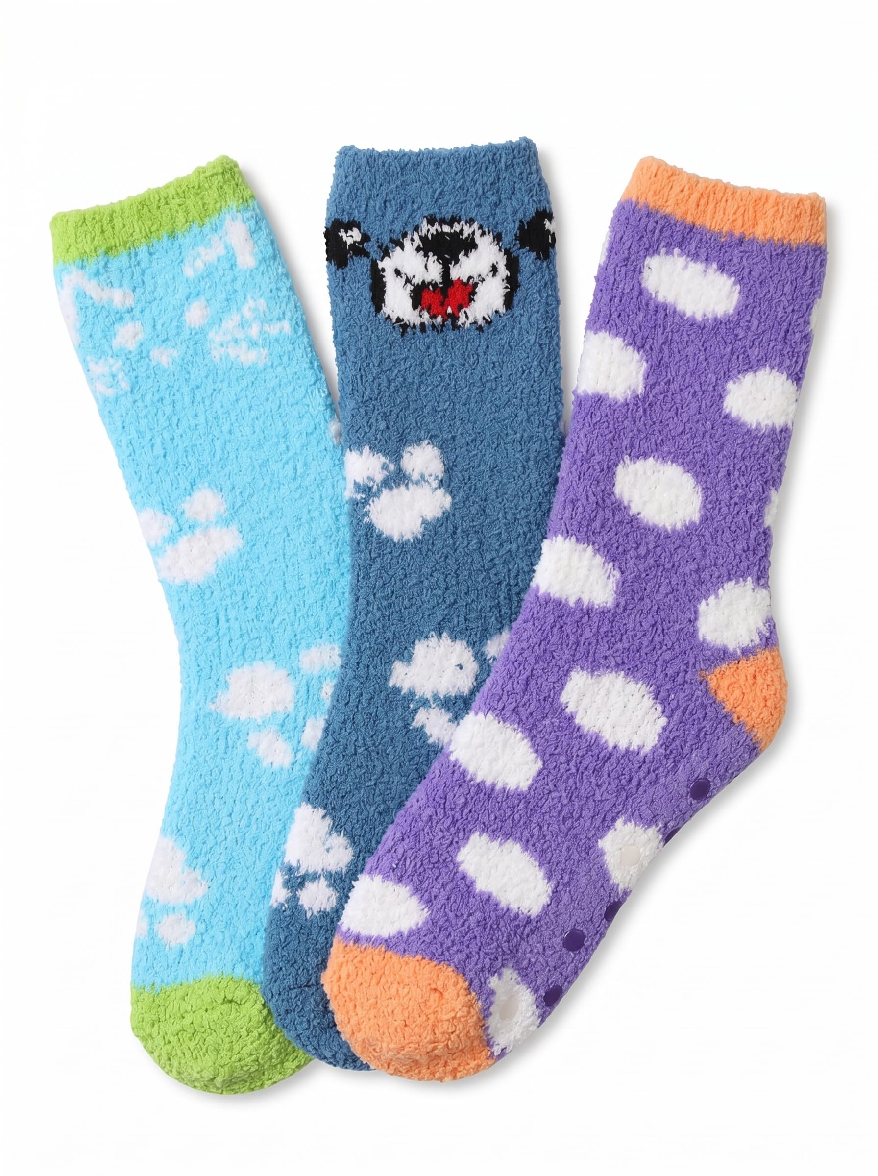 Three fuzzy socks arranged together on a white background: a light blue sock with white paw prints and a green toe/heel, a medium blue sock with a black-and-white bear face and white paw prints, and a purple sock with white polka dots and an orange toe/heel.