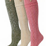 Three knee-high ribbed socks in olive green, cream, and dusty pink, each featuring two decorative buttons near the cuff, displayed against a plain white background.