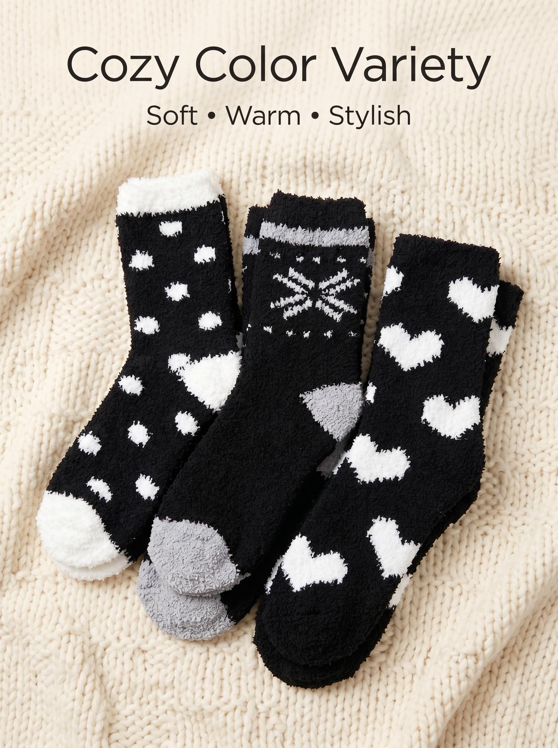 Three pairs of black socks with white and gray patterns on a beige fabric background.