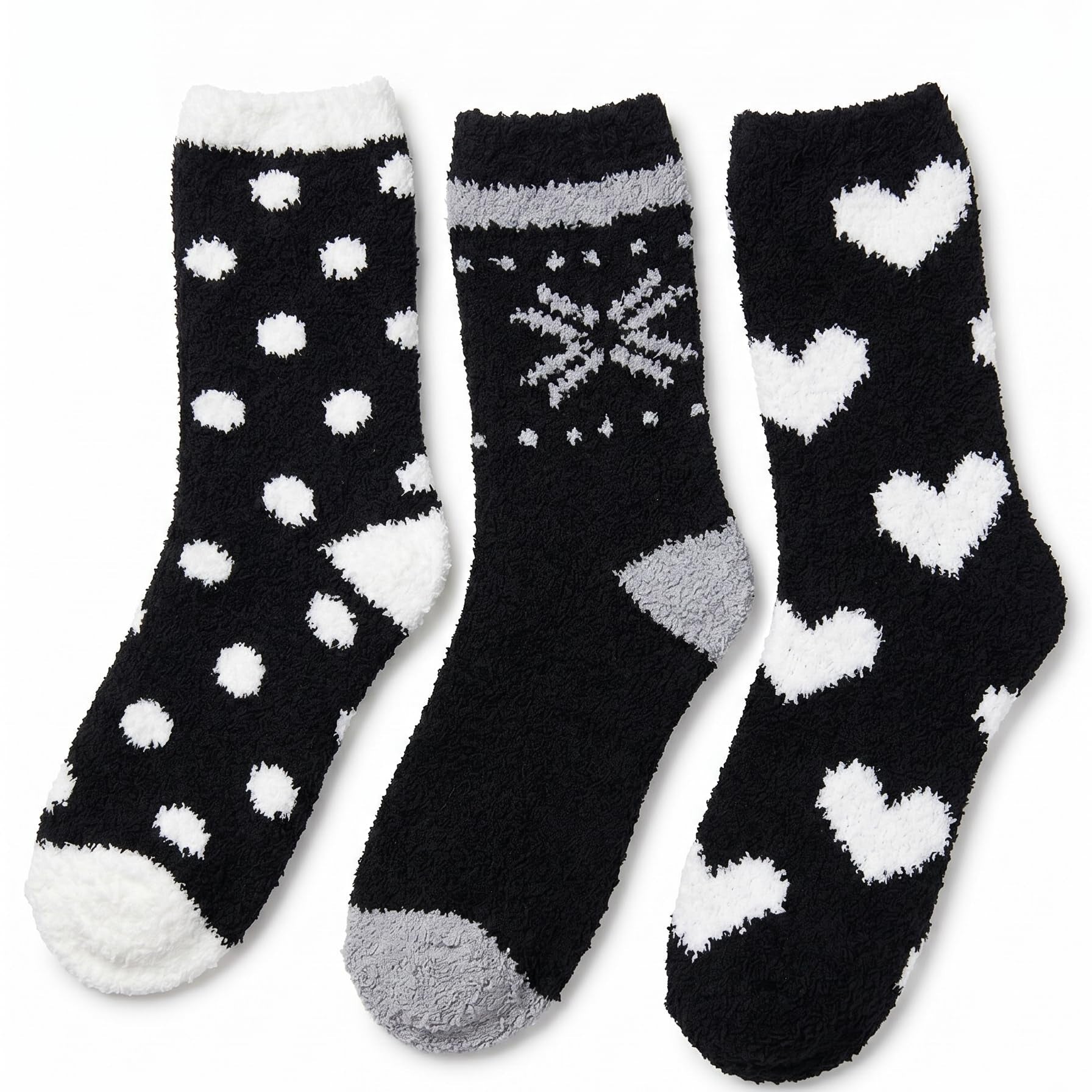 Three pairs of black socks with white patterns on a white background