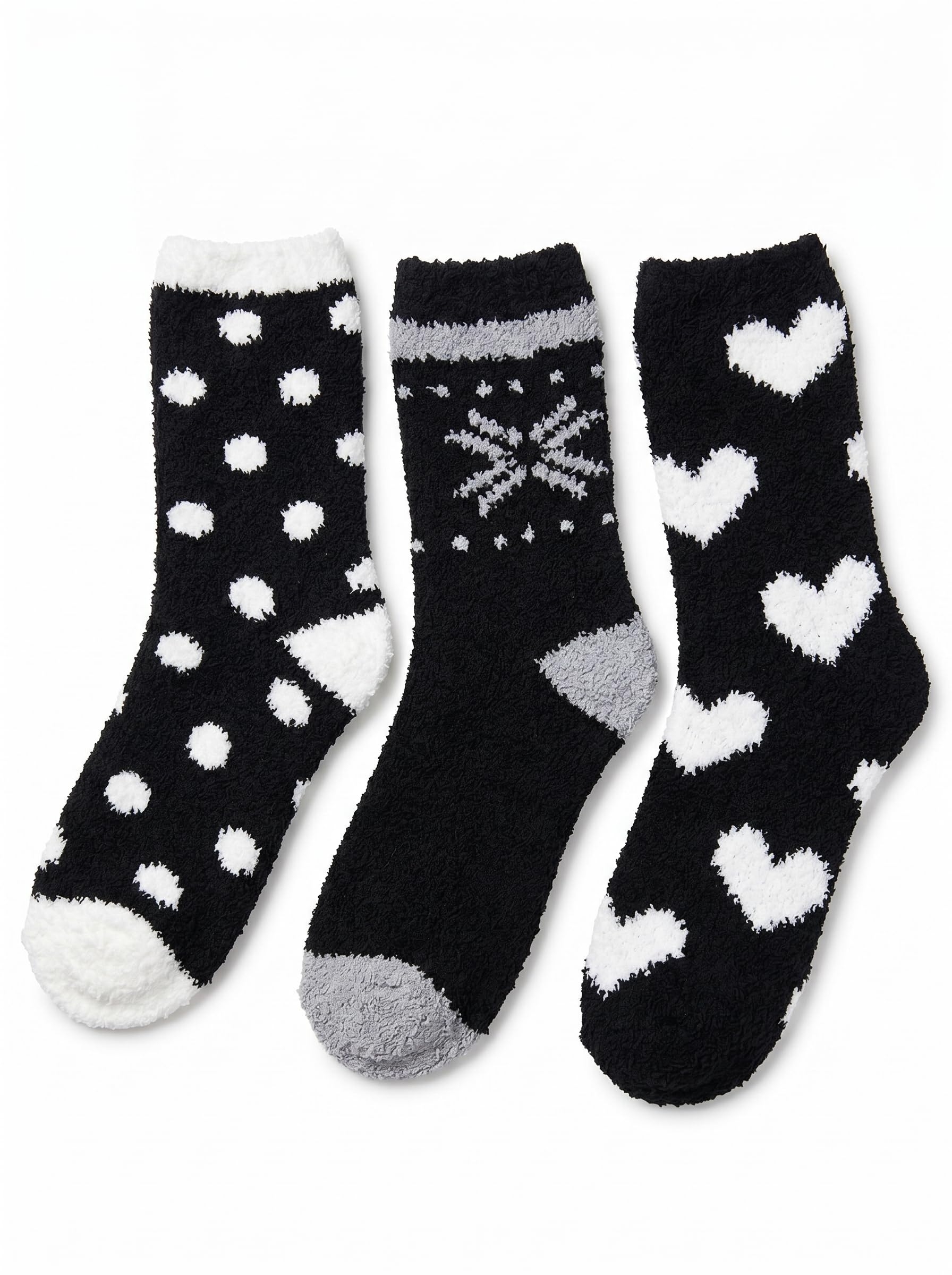 Three pairs of black socks with white patterns on a white background
