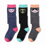Three pairs of crew socks displayed side by side on a white background. The left pair is navy blue with a pink cuff, pink heel, and pink toe, featuring a cat face wearing pink glasses.