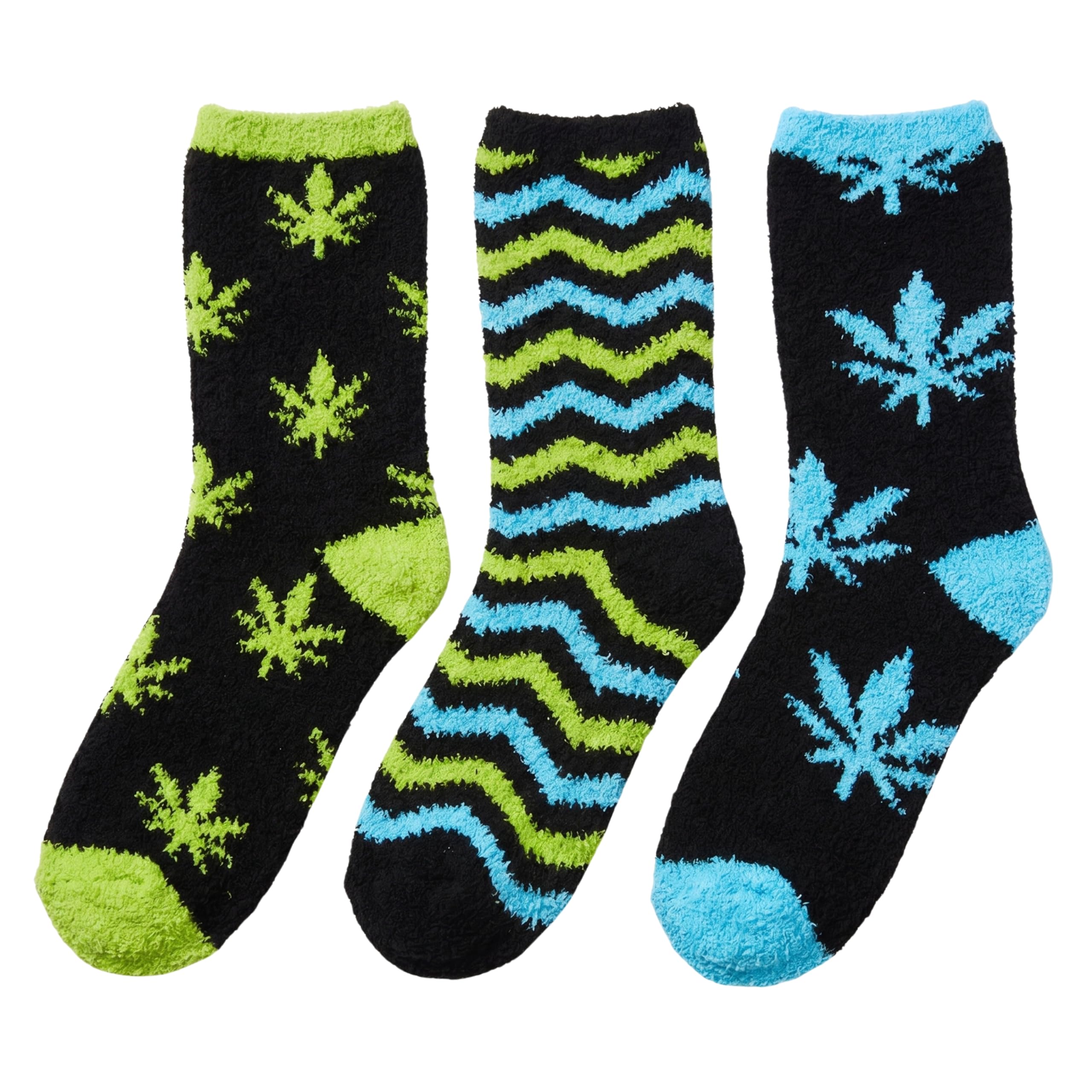 Three pairs of fuzzy crew socks on a plain white background. The left pair is black with lime green cannabis leaf patterns and green toe/heel accents.