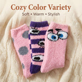 Three pairs of pink and purple socks with cartoon designs on a textured beige background.