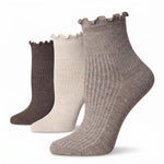 Three ribbed ankle socks with ruffled edges shown in a staggered lineup on a white background. The colors are taupe, cream, and dark brown.