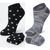 Two pairs of socks, one black with white polka dots and the other gray with a striped pattern, on a white background.