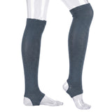 A pair of dark slate blue ribbed knee-high compression socks or leg warmers shown on a clear plastic mannequin leg and foot form against a white background.