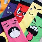 Colorful socks with cartoon face designs arranged in a row.