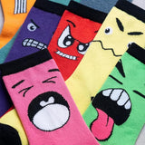 Colorful socks with cartoon face designs arranged in a row.