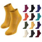 Mustard yellow socks with a grid of various colored socks on a white background