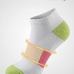White ankle sock with green accents and arch support on a white background