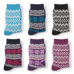Six pairs of patterned knit socks arranged in a 2x3 grid on a white background. The socks feature traditional Fair Isle designs in various colorways: light blue and white, navy and teal, black and white, dark pink and black, lavender and white, and magenta and white.