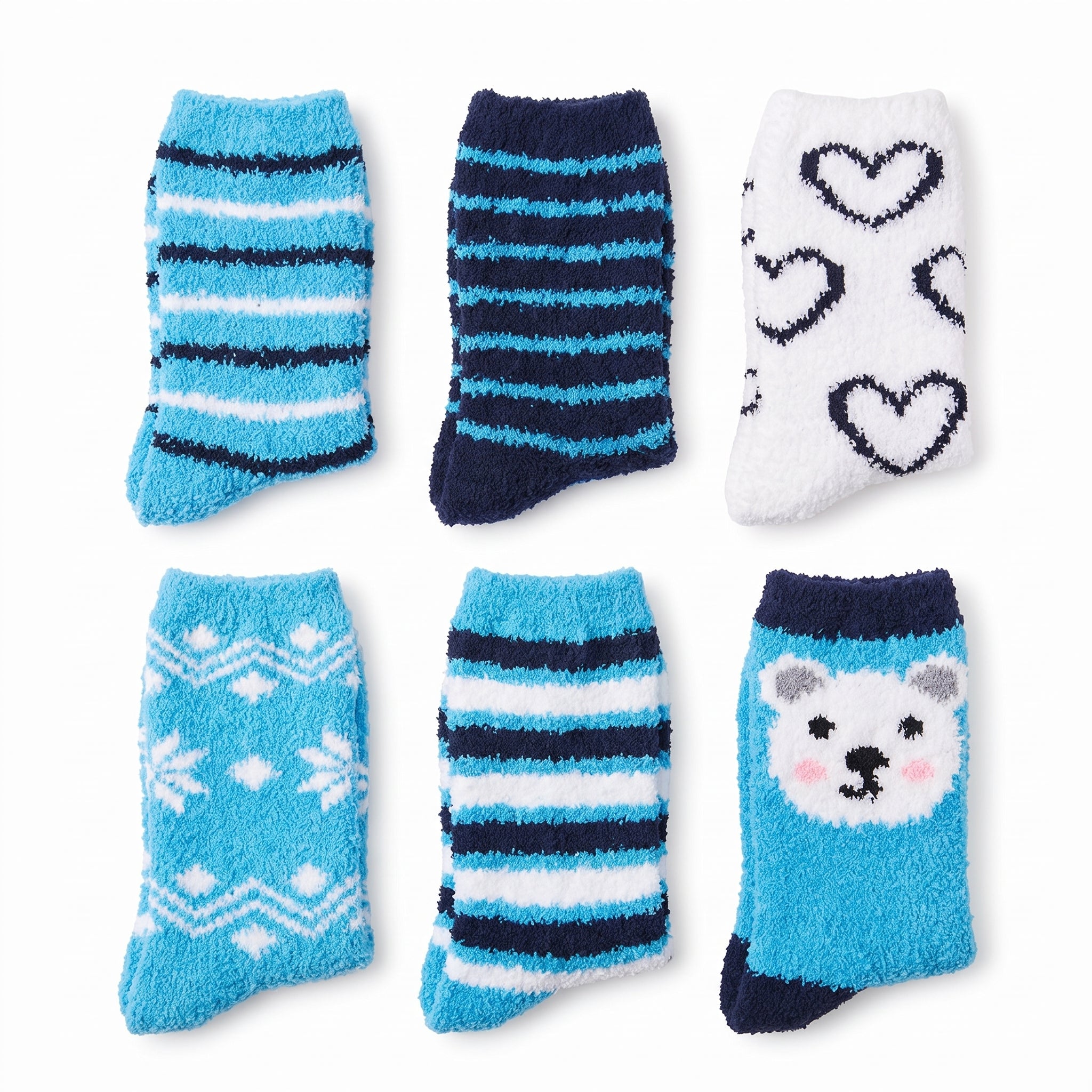 Six pairs of fuzzy socks arranged in a 2x3 grid on a white background. The socks feature various patterns including stripes, hearts, snowflakes, and a polar bear face in shades of blue, navy, and white.