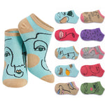 A set of low-cut ankle socks shown on a plain white background, with two larger socks in front and a vertical row of smaller color/style variants behind them. The front socks are light aqua blue with beige toe/heel areas and black line-art facial features; the side variants show different prints and colors including pink, purple, gray, green, and tan.