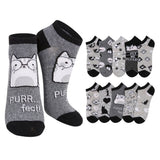 A set of low-cut socks featuring a cat-themed design. The main pair on the left is heather gray with black cuffs, heels, and toes, decorated with a cartoon cat wearing glasses and the text 'PURR.